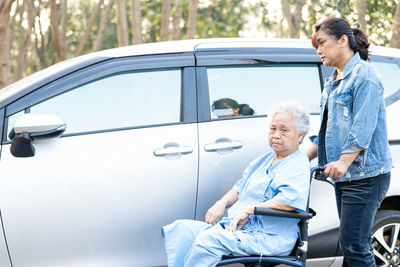 Rear view of man holding car