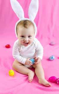 Portrait of cute baby boy playing with toys