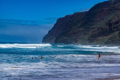 People on beach against sky