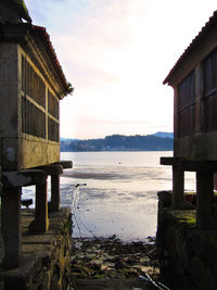 House by sea against sky