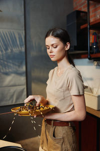 Portrait of young woman sitting on table