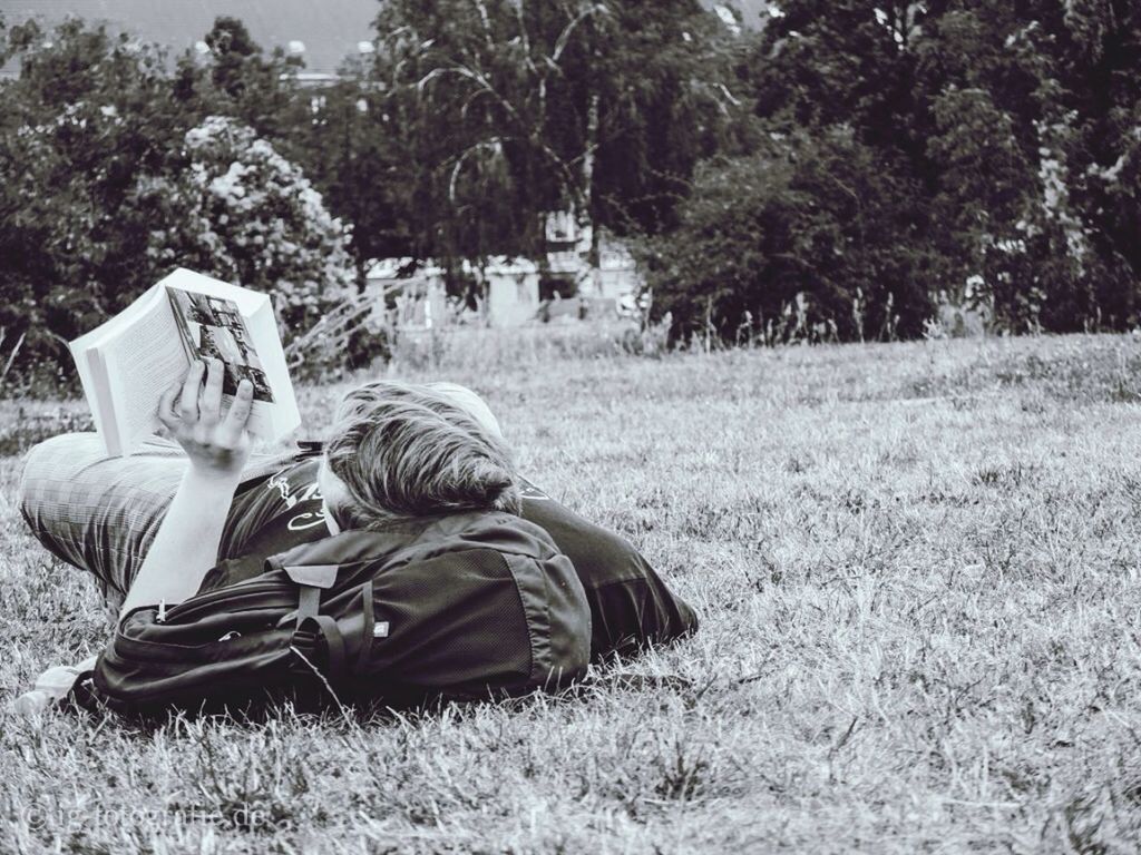 grass, field, tree, sitting, relaxation, grassy, rear view, park - man made space, men, lifestyles, leisure activity, full length, shoe, day, plant, casual clothing, outdoors, growth