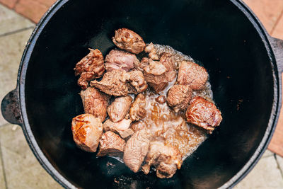 High angle view of meat in cooking pan