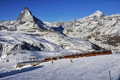 Scenic view of snow covered mountains against clear blue sky,mt matherhorn switzerland