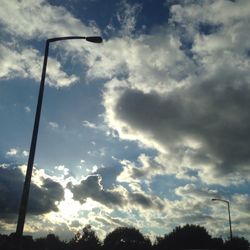 Low angle view of street light against cloudy sky