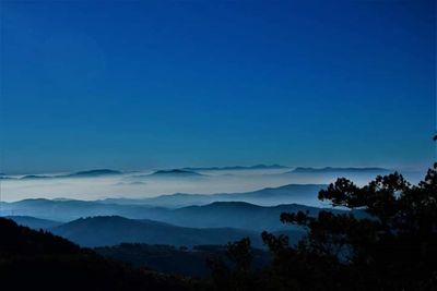 Scenic view of mountains against clear blue sky