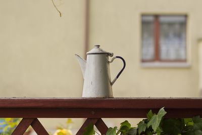 Close-up of electric lamp on table by window