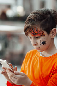 Side view of boy using mobile phone