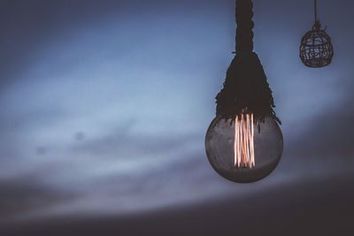 Low angle view of illuminated lamp against sky