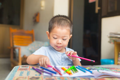 Boy drawing on table at home