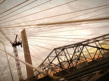 Low angle view of electricity pylon against sky