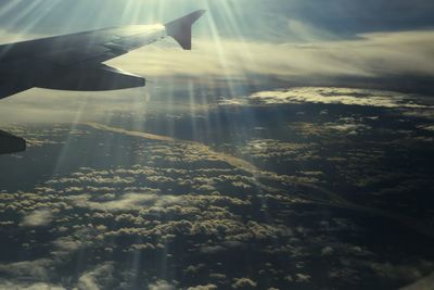 Cropped image of airplane flying over landscape