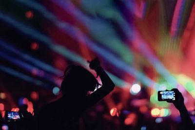 Close-up of hands photographing at night