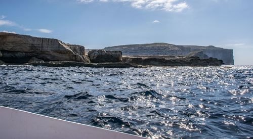 Scenic view of sea and rock formation against sky