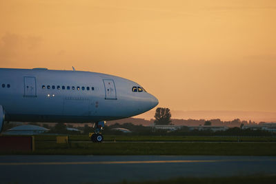 Airplane taxiing to runway for take off. airport at golden sunset.