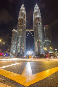 Illuminated city against sky at night