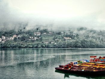 Boat sailing in lake against sky