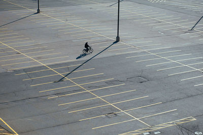 High angle view of man riding bicycle on road