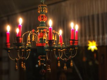 Close-up of lit candles in temple