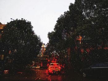 View of wet street in city during rainy season
