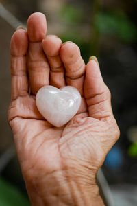 Close-up of hand holding heart shape