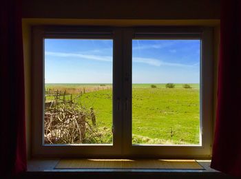 Scenic view of landscape seen through window