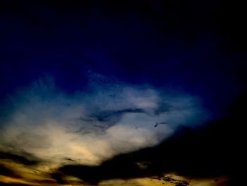 Low angle view of dramatic sky at night