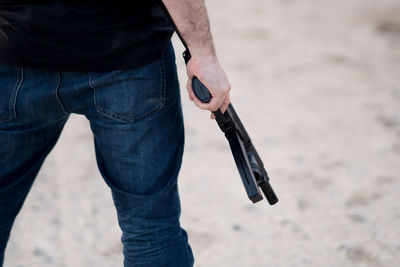 Midsection of man holding sand