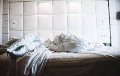 Young man lying on bed at home