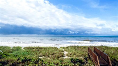 Scenic view of sea against cloudy sky