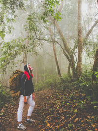 Full length of woman walking in forest