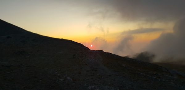 Scenic view of silhouette mountain against sky during sunset