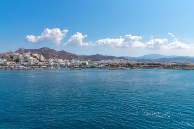 Scenic view of sea by city against sky