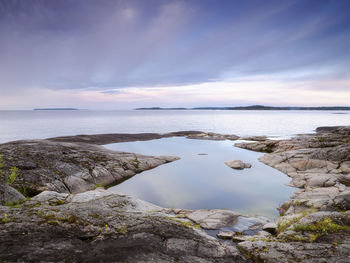 A puddle of calm water on the rocky shore. lake ladoga. republic of karelia, russia