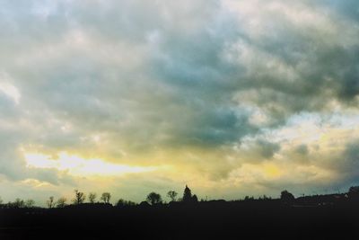 Silhouette of landscape against cloudy sky