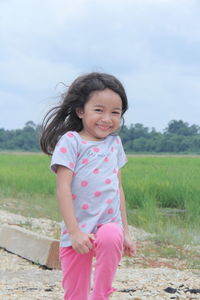Portrait of a smiling girl on field