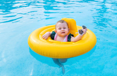 High angle view of boy swimming in lake