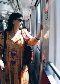 Mid adult woman standing in train