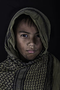 Portrait of beautiful woman against black background