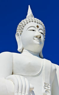 Low angle view of statue against blue sky