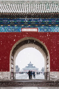 View of building covered with snow in background