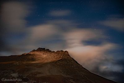 Low angle view of mountain against sky at night