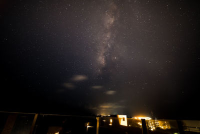 Low angle view of illuminated building against sky at night
