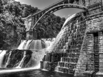 Low angle view of bridge over waterfall