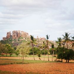 Scenic view of landscape against cloudy sky