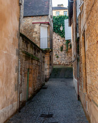 Narrow alley amidst buildings in city