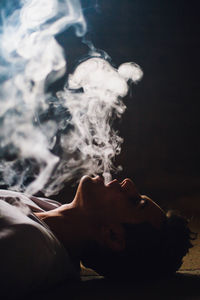 Close-up of young man smoking cigarette