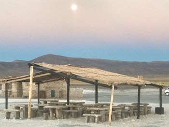 Built structure on beach against clear sky