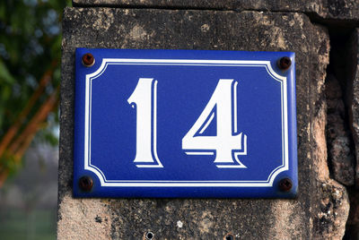 Close-up of number 14 board mounted on wall