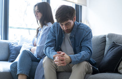 Friends using laptop at home